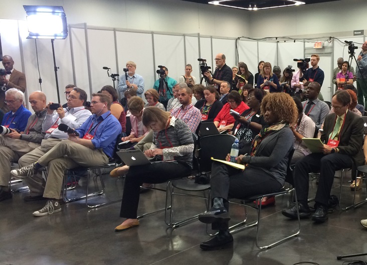 press-conference-gc2016-portland Credentialed press crowd into a news conference hosted by United Methodist Communications at the 2016 General Conference in Portland, Oregon. Photo by Laura Buchanan, United Methodist Communications.