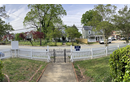 Missionary Julie Wilson tracks the progress of gentrification in her Winston-Salem neighborhood by looking out the front door. The community members Open Arms serves are increasingly losing their rental homes to people who can purchase and rebuild them. The view from the porch of Open Arms Community center in Winston-Salem, NC, shows three recently purchased homes undergoing renovations. Photo: Julie Wilson.
