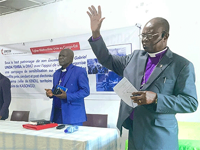 United Methodist Bishop Gabriel Yemba Unda (right) prays for peace and tolerance during elections in Congo. Unda reaffirmed the church's duty to promote peace and will continue efforts to help prevent violence. Photo by Chadrack Tambwe Londe, UM News.